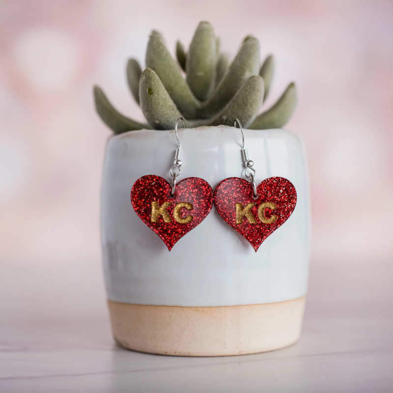 Show your love for the game, in our KC Glitter Glam Heart Dangles and Stud Earrings.  The perfect pop of color + sparkle for game time! Super lightweight and comfortable, you'll forget you have them on.