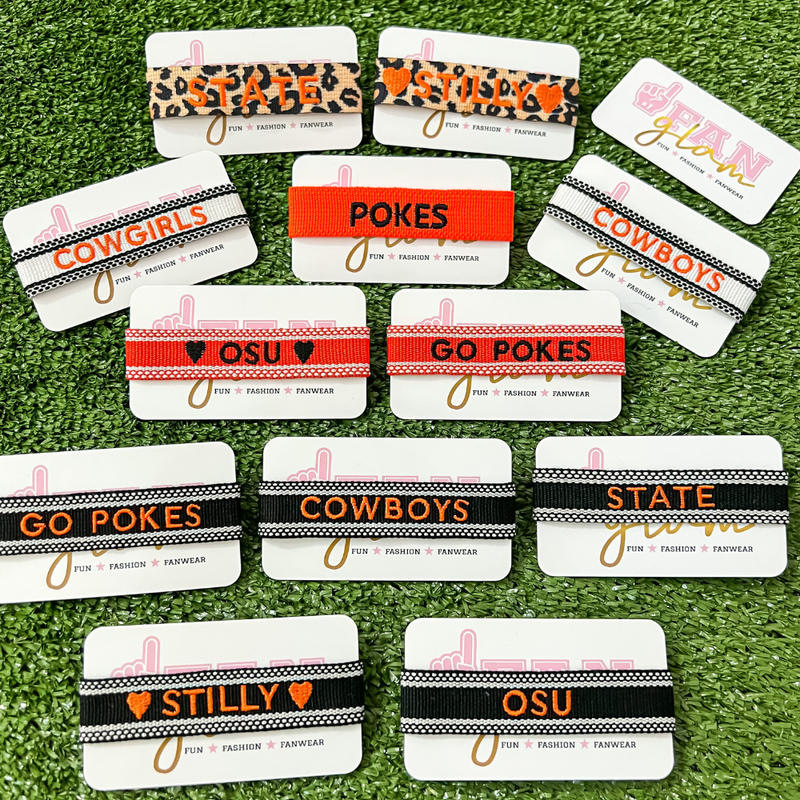 Your team. Your squad. Your identity.    Our Oklahoma Sate Game Day Team Tassels have arrived and can now be customized!  Elevate your GameDay stack and personalize your tassel with your favorite team / motto / or mascot!     Experience high-end fashion that takes you from tailgate to postgame and everywhere in between!  