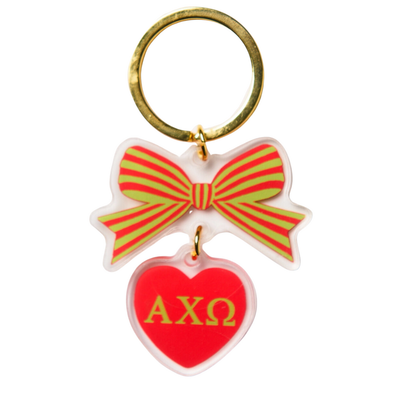 Add a splash of charm to your keys with the Alpha Chi Omega Bow-Dacious Key Chain! Featuring a delightful bow design accented with your sorority letters, this playful accessory is perfect for showing off your sisterhood pride in style. Compact and cute, it’s an ideal gift or a fun treat for yourself to keep your keys looking fabulous.