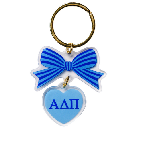 Add a splash of charm to your keys with the Alpha Chi Omega Bow-Dacious Key Chain! Featuring a delightful bow design accented with your sorority letters, this playful accessory is perfect for showing off your sisterhood pride in style. Compact and cute, it’s an ideal gift or a fun treat for yourself to keep your keys looking fabulous.