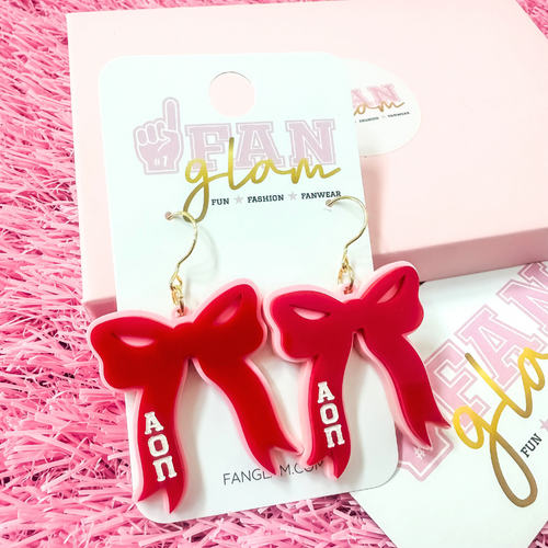 Add the perfect finishing touch to your Bid Day look with our Bid Day Bow Earrings! These bold, lightweight bows are designed to show off your chapter spirit with style and sparkle. Pair them with your favorite Bid Day fit for a look that's full of fun and sisterhood pride!