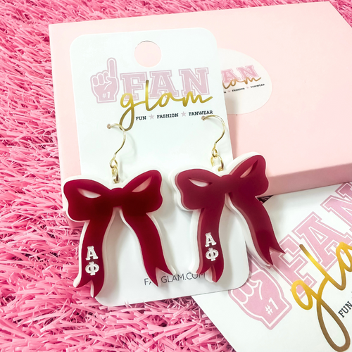 Add the perfect finishing touch to your Bid Day look with our Bid Day Bow Earrings! These bold, lightweight bows are designed to show off your chapter spirit with style and sparkle. Pair them with your favorite Bid Day fit for a look that's full of fun and sisterhood pride!