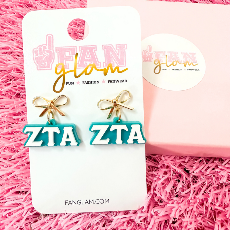 Add a little glam to your Greek life with our Gold Bow Chapter Charms! These sweet drop earrings feature a dainty metallic bow paired with bold, bubbly sorority letters—perfect for Bid Day, Big/Little reveals, or just repping your chapter with style.