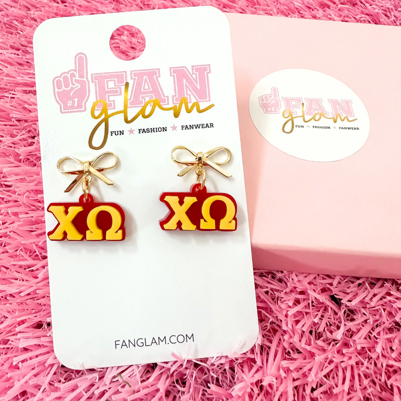 Add a little glam to your Greek life with our Gold Bow Chapter Charms! These sweet drop earrings feature a dainty metallic bow paired with bold, bubbly sorority letters—perfect for Bid Day, Big/Little reveals, or just repping your chapter with style.