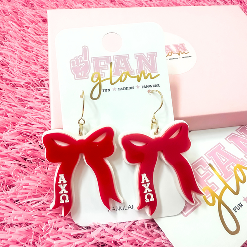 Add the perfect finishing touch to your Bid Day look with our Bid Day Bow Earrings! These bold, lightweight bows are designed to show off your chapter spirit with style and sparkle. Pair them with your favorite Bid Day fit for a look that's full of fun and sisterhood pride!