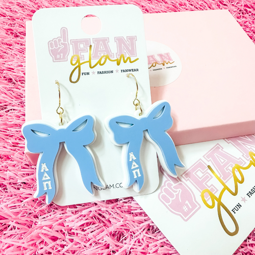 Add the perfect finishing touch to your Bid Day look with our Bid Day Bow Earrings! These bold, lightweight bows are designed to show off your chapter spirit with style and sparkle. Pair them with your favorite Bid Day fit for a look that's full of fun and sisterhood pride!