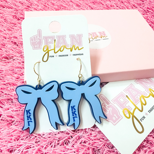 Add the perfect finishing touch to your Bid Day look with our Bid Day Bow Earrings! These bold, lightweight bows are designed to show off your chapter spirit with style and sparkle. Pair them with your favorite Bid Day fit for a look that's full of fun and sisterhood pride!