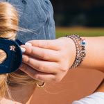 On Gameday, hold your hair and enhance your style with TELETIES. The strong grip, no rip hair tie that doubles as a bracelet. Strong, pretty, and stylish, TELETIES are designed to withstand everyday demands while taking your Gameday look to the next level.