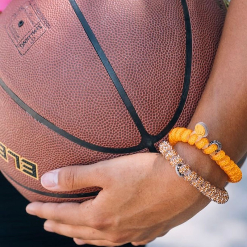 TELETIES - BASKETBALL SPORTS COLLECTION  On Gameday, hold your hair and enhance your style with TELETIES. The strong grip, no rip hair tie that doubles as a bracelet. Strong, pretty and stylish, TELETIES are designed to withstand everyday demands while taking your Gameday look to the next level.