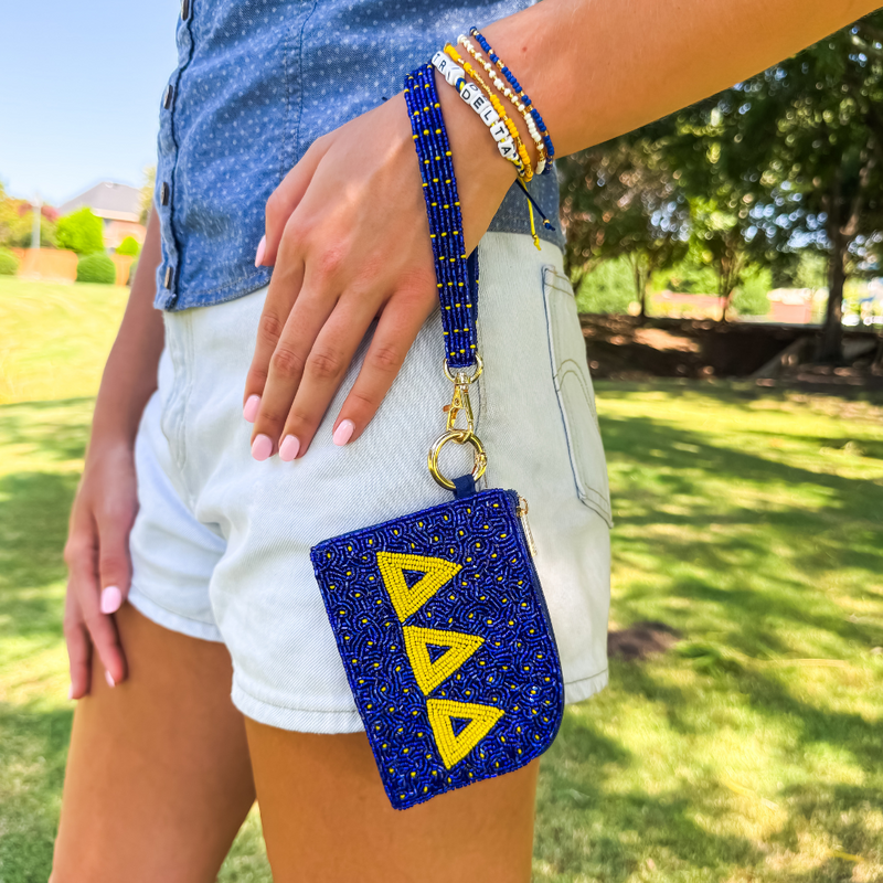 Show your sisterhood spirit in style with our exclusive Delta Delta Delta Beaded Bracelet Bag! Designed to be worn on your wrist or clipped to your favorite bag, this lightweight and eye-catching accessory is perfect for any greek event! From Bid Day to Big/Little reveal, it's the perfect way to show off your letters with pride!