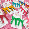 Add the perfect finishing touch to your Bid Day look with our Bid Day Bow Earrings! These bold, lightweight bows are designed to show off your chapter spirit with style and sparkle. Pair them with your favorite Bid Day fit for a look that's full of fun and sisterhood pride!