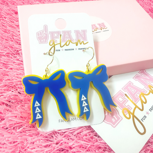 Add the perfect finishing touch to your Bid Day look with our Bid Day Bow Earrings! These bold, lightweight bows are designed to show off your chapter spirit with style and sparkle. Pair them with your favorite Bid Day fit for a look that's full of fun and sisterhood pride!