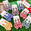 Show your love for the game when accessorizing your Game Day look with our exclusive dual colored beaded football earrings!    The perfect accessory to coordinate with your Friday Night Lights ensemble or Saturday tailgate style.