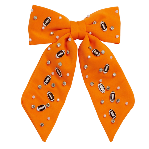 Bring a burst of team pride to any look with our Football Charm Game Day Hair Bow. Bright, bold, and full of school spirit, this eye-catching accessory has beautiful beading details with enamel football charms. Lightweight and versatile, it’s the perfect finishing touch for showing off your colors—on game day and beyond.