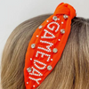 Our NEW rhinestone be-jeweled "Game Day" headbands, feature a trendy knotted design and are adorned with sparkling rhinestones and dual colored beads arranged in a playful "Gameday" pattern.  This headband is perfect for showing off your team spirit at sporting events, tailgates, or any other gameday celebration. 