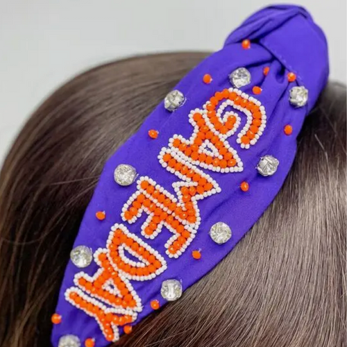 Our NEW rhinestone be-jeweled "Game Day" headbands, feature a trendy knotted design and are adorned with sparkling rhinestones and dual colored beads arranged in a playful "Gameday" pattern.  This headband is perfect for showing off your team spirit at sporting events, tailgates, or any other gameday celebration.