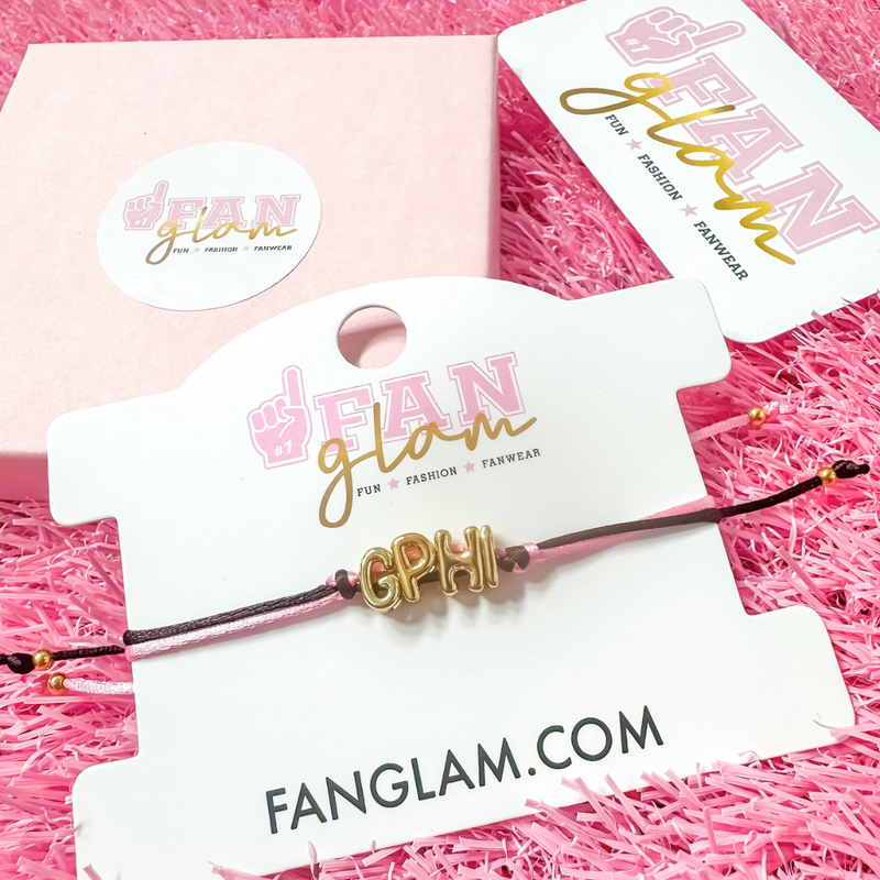 Our new cinch tie bracelets are the perfect pop of Greek glam — stackable, adjustable, and so on trend! Whether you are spoiling your Little, surprising your Big, or celebrating Bid Day, our gold letter greek bracelet adds just the right sparkle to every sorority moment.

With its comfy fit and meaningful charm, it's the go-to gift for your Greek fam — because sisterhood looks good on you!