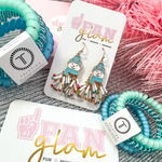 Tis the season to sparkle!  Don't miss out on the best ear candy in town.  Our colorful Holiday Fringe multi colored Glam dangles are a show stopper and will become the talk of the entire party. 