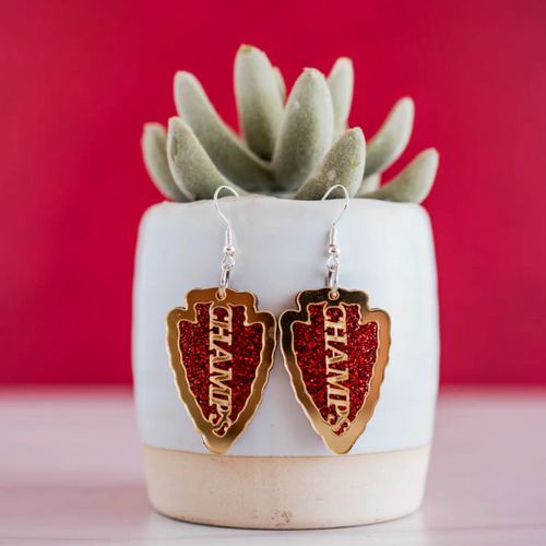 Back To Back Champs!   Show your KC pride in our new red glitter + gold mirror CHAMPS arrowhead dangle earrings.  The perfect pop of color + sparkle to show off your team pride! Super lightweight and comfortable, you'll forget you have them on.