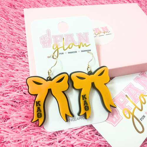 Add the perfect finishing touch to your Bid Day look with our Bid Day Bow Earrings! These bold, lightweight bows are designed to show off your chapter spirit with style and sparkle. Pair them with your favorite Bid Day fit for a look that's full of fun and sisterhood pride!