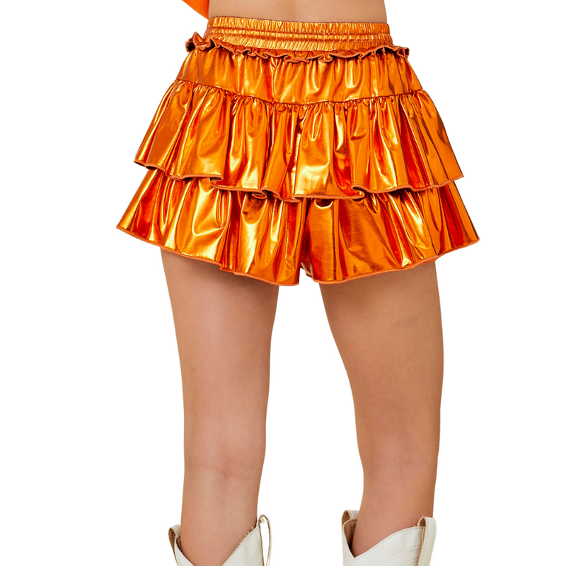 Our Metallic Skort is here to steal the spotlight in orange, purple, or red!&nbsp;With a flirty fit, fierce shine, and built-in shorts for all-day comfort, it's made for dancing, cheering, and being the most extra in the stands. Pair it with your fave tee and let the glam do the talking!