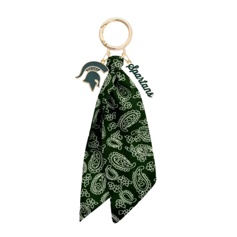 Show off your Spartan pride with this playful Michigan State Spartans Logo Bandana Bag Charm. Perfect for adding a splash of team spirit to your bag, keys, or backpack, this charm brings fun and fandom together in one stylish accessory. Lightweight and easy to attach, it’s a must-have for any true Spartan fan looking to keep their team close wherever they go.