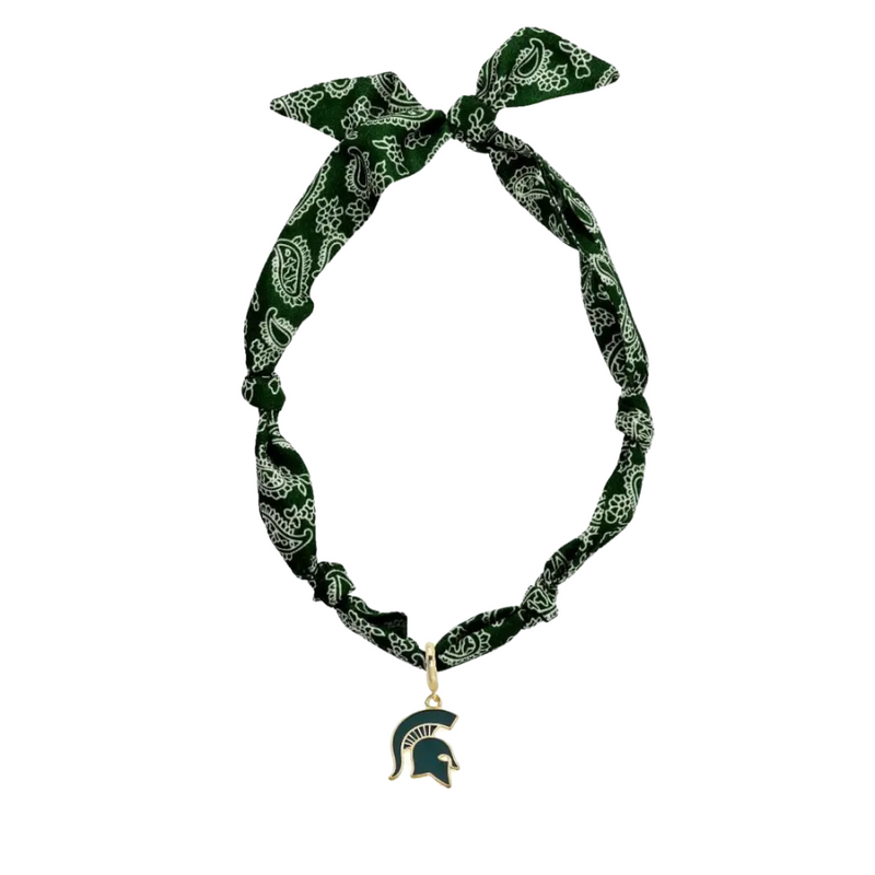 Add a playful twist to your game day outfit with the Michigan State Logo Bandana Scarf Necklace. This fun accessory combines a soft, comfortable bandana scarf with a shiny gold-plated logo pendant, letting you show off your team spirit in style. Perfect for fans who want to blend fashion and fandom effortlessly!