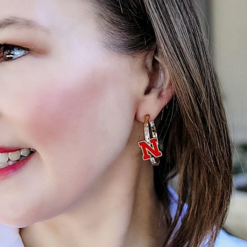 Go BIG RED!! Stand out from the crowd and let everyone know which team you root for with these stylish and spirited accessories.

Wear your Nebraska Cornhuskers Logo Enamel Hoop Earrings to enhance your game day look or add a touch of team spirit to your everyday attire.