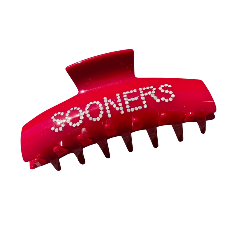 Introducing our latest claw clips in bold crimson and cream — made just for Sooner Nation! With bedazzled OU lettering and a comfy, secure grip, this clip brings sparkle, spirit, and serious style to your everyday look. From class to kickoff, this is how Sooners slay.