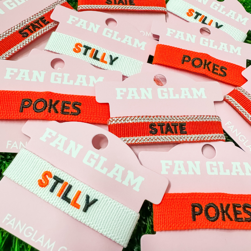 Your team. Your squad. Your identity. &nbsp;

Our custom Oklahoma Sate Game Day Team Tassels have arrived!&nbsp; Experience high-end fashion that takes you from tailgate to postgame and everywhere in between!&nbsp; Select from three of our new favorite Oklahoma State designs!