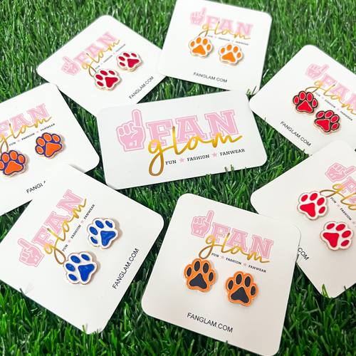 Just In!!  The PAWFECT sporty + chic dual colored paw stud earrings, our NEW GameDay favorite!    Available in eight fun sport team color options, collect all your favorite teams colors.