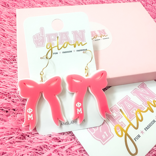 Add the perfect finishing touch to your Bid Day look with our Bid Day Bow Earrings! These bold, lightweight bows are designed to show off your chapter spirit with style and sparkle. Pair them with your favorite Bid Day fit for a look that's full of fun and sisterhood pride!