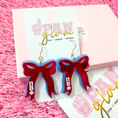 Add the perfect finishing touch to your Bid Day look with our Bid Day Bow Earrings! These bold, lightweight bows are designed to show off your chapter spirit with style and sparkle. Pair them with your favorite Bid Day fit for a look that's full of fun and sisterhood pride!