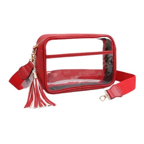 It's Here!!! Our Game Day stadium compliant crossbody zip bag! Featuring a clear PVC body with red trim and gold metal accents. Comfortable and roomy, this bag is perfect for the Game Day girl who likes to come prepared!
