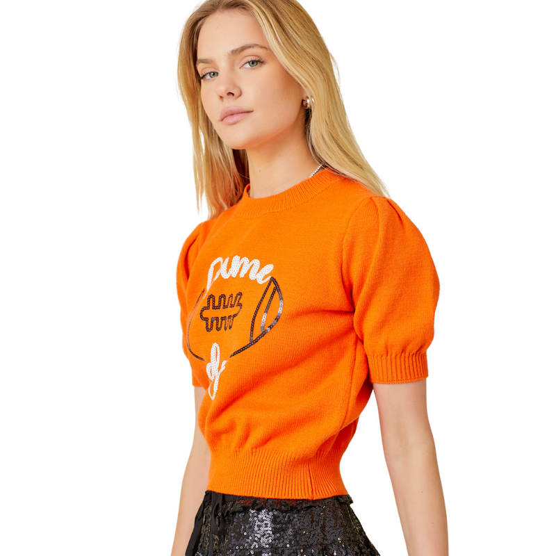 Our red Game Day Puff Sleeve Sweater Top is a total win for your game day lineup. Featuring bold embroidered "Game Day" lettering and a front-and-center football graphic, this vibrant knit brings the hype. Puff sleeves add a playful, girly edge, while the standout red color makes sure all eyes are on you—from the lot to the stands.