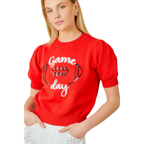 Our red Game Day Puff Sleeve Sweater Top is a total win for your game day lineup. Featuring bold embroidered "Game Day" lettering and a front-and-center football graphic, this vibrant knit brings the hype. Puff sleeves add a playful, girly edge, while the standout red color makes sure all eyes are on you—from the lot to the stands.
