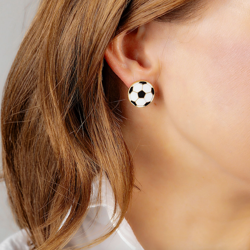 Get ready for Game Time in our new Soccer Enamel Stud Earrings.&nbsp; A new on and off the field fan favorite, these sports ball studs are classic and stylish featuring gold accents and plating.