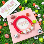 Our Sports Ball Charm beaded accent bracelets are a perfect addition to your Game Day Stack.  Simple and chic you can even mix and match multiple sports balls for the perfect layering stack in any of your favorite team colors. 