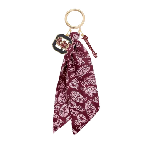 Bring the fun wherever you go with this game day-ready bag charm! Featuring a bold paisley-print bandana, shiny gold hardware, and sporty charm accents, it’s the ultimate way to show your spirit in style. Clip it to your bag, keys, or backpack and let the tailgate vibes follow you everywhere. Perfect for cheering, repping your team, or just adding a pop of personality to your look!