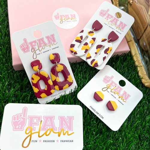 Our GameDay Tam Clay Co Maroon & Gold Collection features four fun collectable styles.  With custom team colors and sporty stripes these one-of-a-kind clay designs will add some print and pizzazz to your Game Day attire.