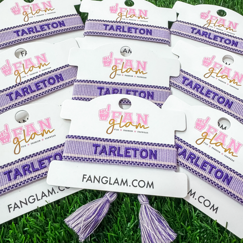 Bleed Purple and Stand Tall wearing our exclusive Tarleton Tassel Bracelet! Featuring bold embroidery on a chic two toned purple woven band, this adjustable bracelet is perfect for game days, tailgates, and showing off your Texan pride.

With stylish tassel accents, it’s the perfect accessory for any true Tarleton State fan. Go Texans!