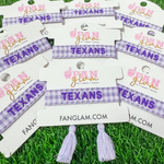 Bleed Purple and Stand Tall wearing our Tarleton Texans Tassel Bracelet! Featuring bold TEXANS embroidery on a chic purple and white gingham woven band, this adjustable bracelet is perfect for game days, tailgates, and showing off your Texan pride.

With stylish tassel accents, it’s the perfect accessory for any true Tarleton State fan. Go Texans!