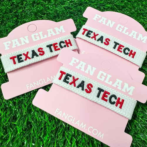 "Wreck ‘Em, Tech! Show off your Red Raider pride with this stylish woven bracelet! Featuring bold ‘TEXAS TECH’ embroidery on a white band, this adjustable bracelet is perfect for game days, tailgates, or everyday wear. Whether you're chanting ‘Guns Up!’ or singing the Matador Song, this bracelet is a must-have accessory for any Texas Tech fan!"