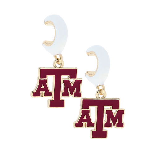 Show off your Aggie pride with a touch of sparkle! These Texas A&amp;M Aggies Enamel Logo Huggie Hoop Earrings feature the iconic logo in crisp white enamel, nestled in shiny gold hoops. Perfect for game day or everyday wear, they add a playful yet polished pop of team spirit to any outfit.