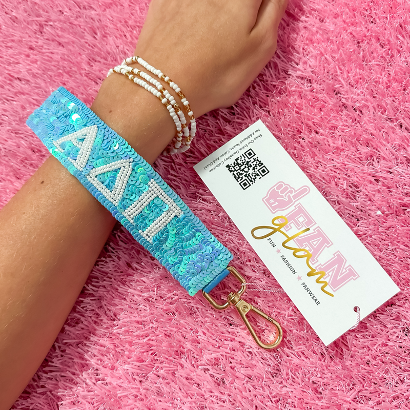 Greek Glam just dropped! This wristlet is serving sparkle, shine, and serious sorority energy — fully sequined and reppin’ your letters loud and proud.&nbsp;Whether you’re heading to chapter, running to class, or getting gift-ready for Bid Day or Big/Little, this piece brings the perfect pop of sorority style. Clip it on, show it off, and let your Greek girl era shine&nbsp;