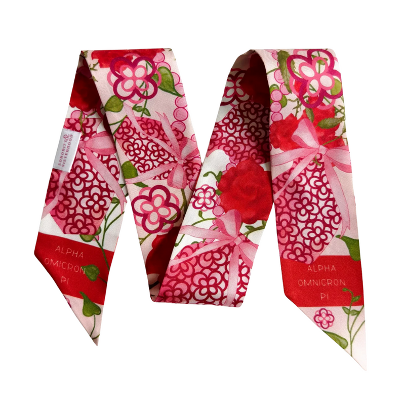 Calling all AOII sisters! This silky scarflette is your new BFF for flaunting those cardinal red and white connections! Wrap it around your bag for a pop of pizzazz, twist it in your hair for sorority-chic vibes, or rock it as a neck accessory that screams "yes, I'm fabulous AND in Alpha Omicron Pi!" Perfect for gifting to your ride-or-die sisters or treating yourself to a daily dose of AOII magic. Because nothing says "I crushed sorority life" quite like this playful piece of wearable sisterhood!