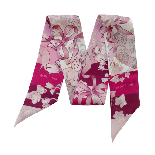 Pop some Phi-nomenal fun into your wardrobe with this silky Alpha Phi scarflette! This little fashion sidekick brings sisterhood vibes to any outfit – whether you're crushing it at work or dancing at brunch! Twist it, tie it, flaunt it – this playful piece is your secret weapon for turning heads and sparking "OMG where did you get that?!" conversations! Perfect for surprising your favorite Alpha Phi bestie or treating yourself to a daily dose of sorority sparkle. Because adulting is hard, but looking Phi-ab