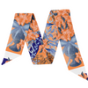 War Eagle, but make it fashion. This gorgeous scarflette channels the heart of Auburn with bold burnt orange, deep navy, and crisp white accents — the ultimate tribute to the Auburn family’s iconic colors.