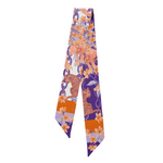 Celebrate your Clemson pride with the South Carolina Silk Scarflette! This playful accessory adds a vibrant touch of Tigers spirit to any outfit. Whether you're cheering at the game or showing off your love around town, its silky texture and bold colors make it a fun and stylish way to support your team. Roar on, Tigers!