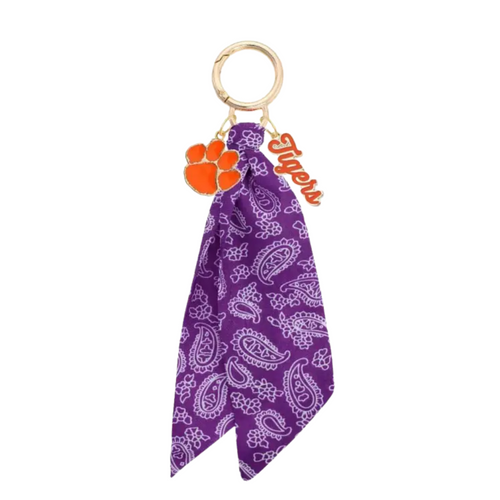 Show off your Clemson Tigers pride with this playful logo bandana bag charm. Perfect for adding a splash of team spirit to your purse, backpack, or keys, it’s a fun and stylish way to keep your favorite team close wherever you go. Lightweight and easy to attach, this charm is a must-have for any Tigers fan looking to add a little extra flair to their everyday look.